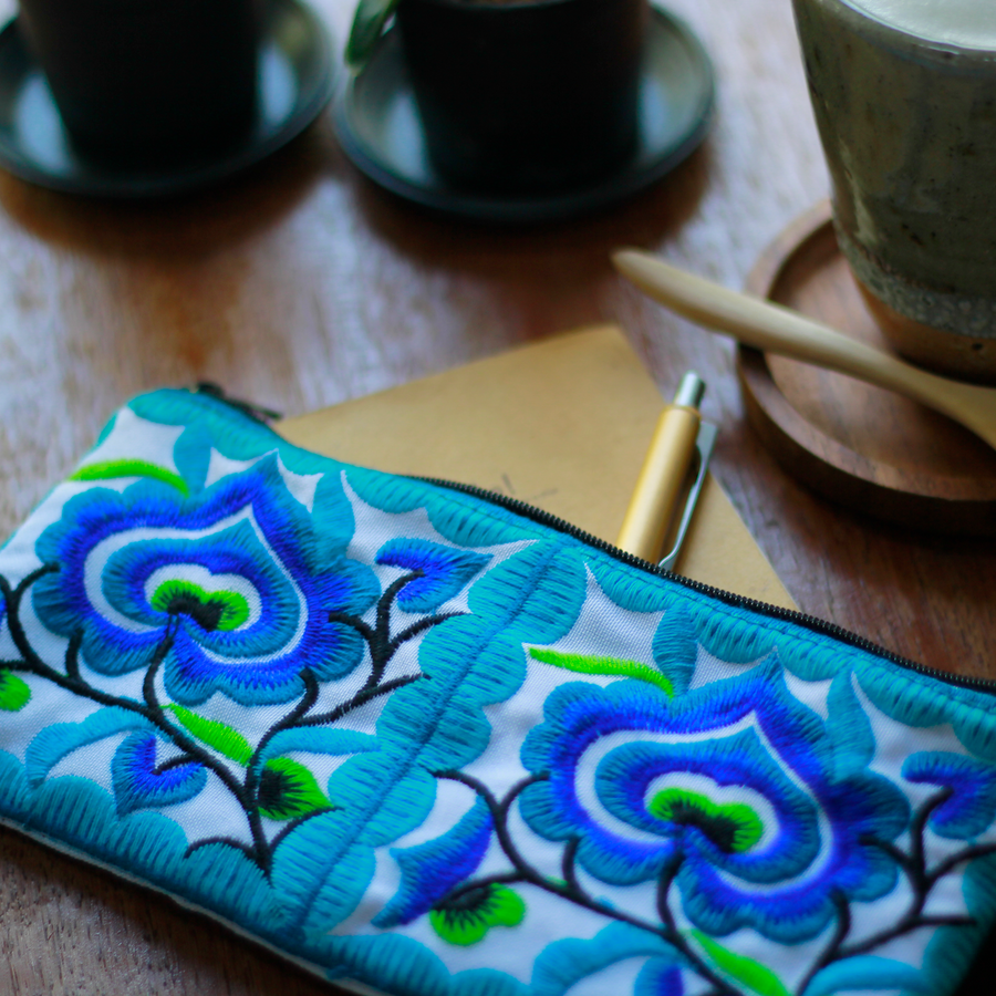 Sabai Jai Blue Small Floral Wristlet on table