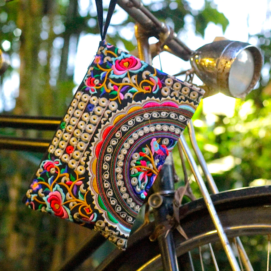 Sabai Jai Silver & Multicolor Rose Clutch front of bike