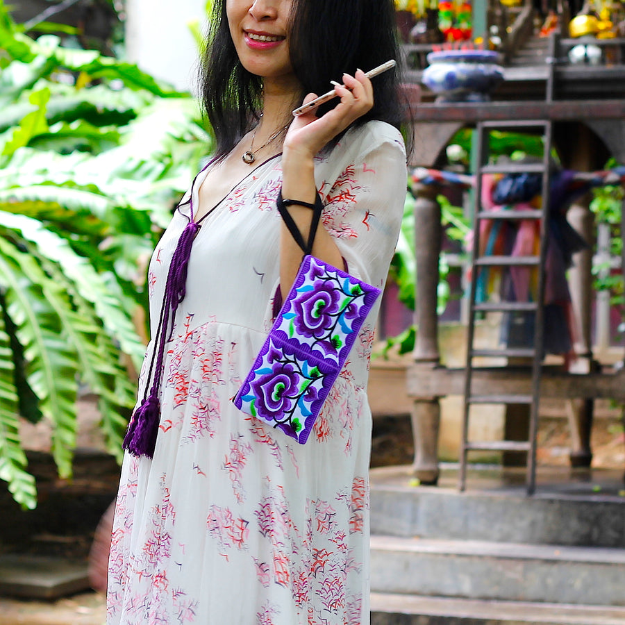 Sabai Jai Purple Small Floral Wristlet held by woman